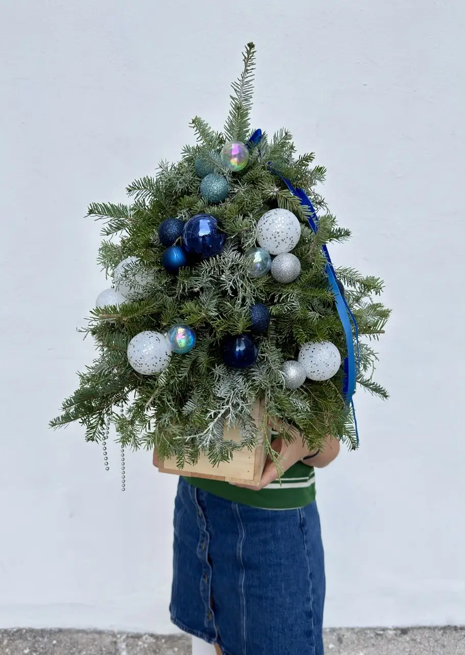 blue and silver Christmas tree with decorated Christmas greenery