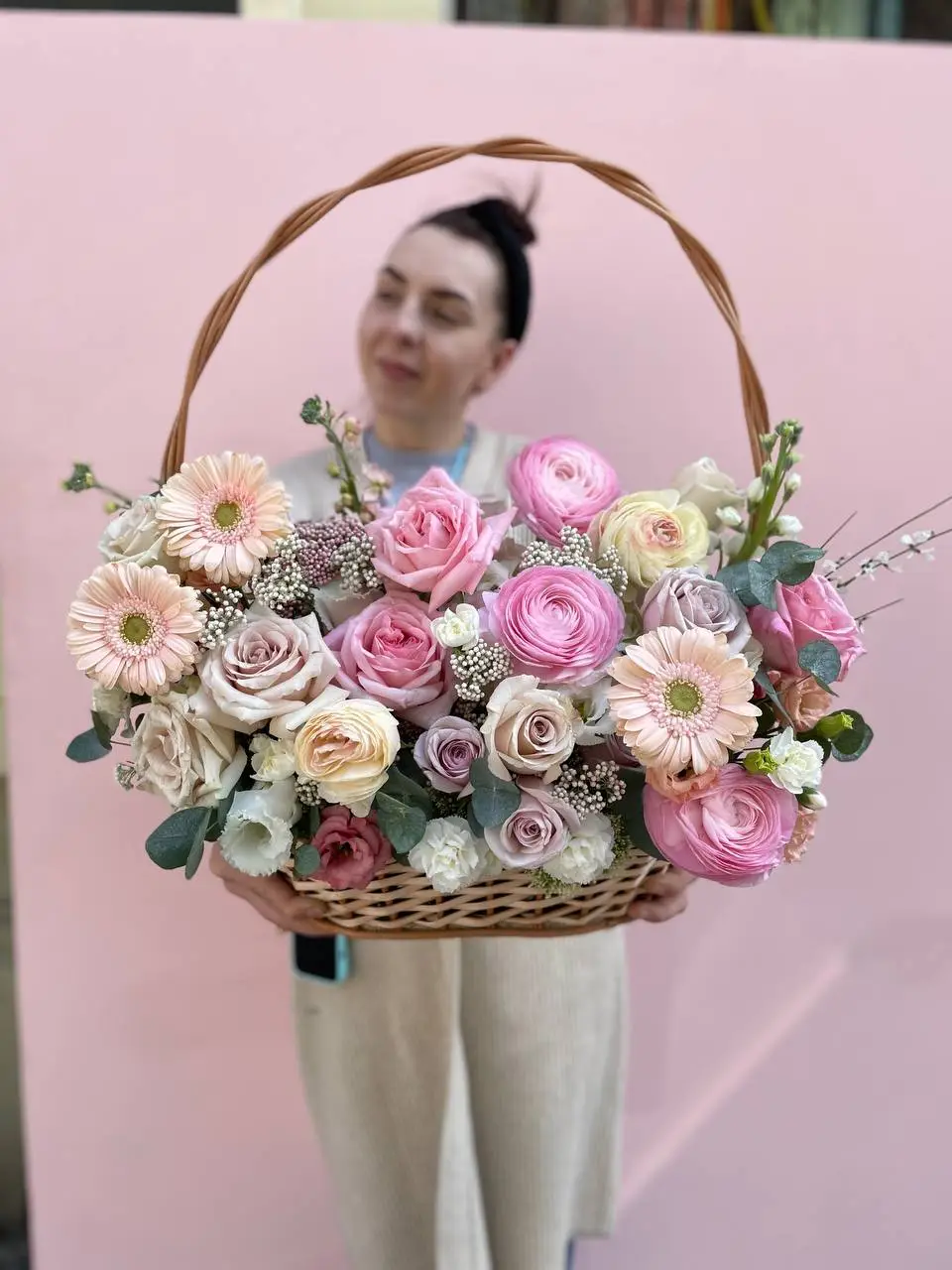 Flower basket arrangement with pink and cream roses ranunculus stock and gerberas