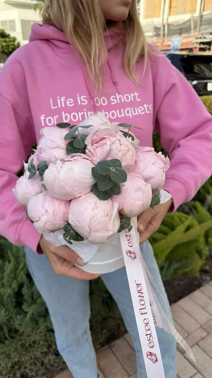 Hat box with peonies and eucalyptus flower arrangement