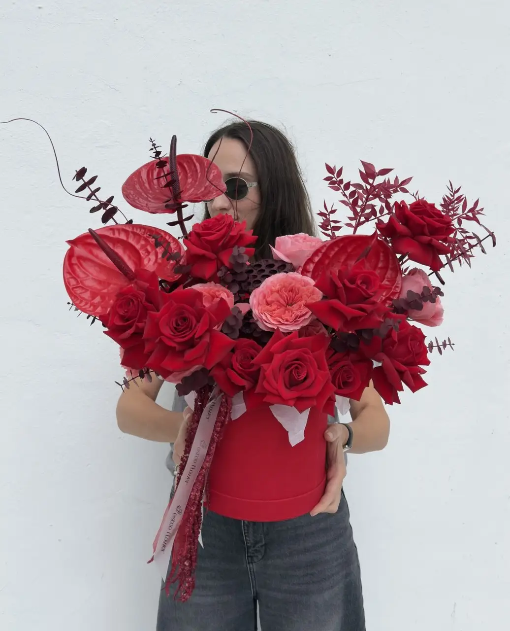 hat box flowers with red roses and anthuriums arrangement
